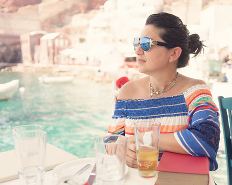 Woman at a restaurant in Santorini