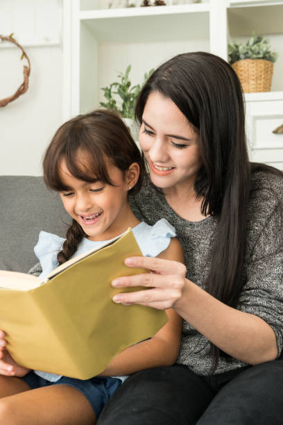 istock mother reading a book with daughter 814593736