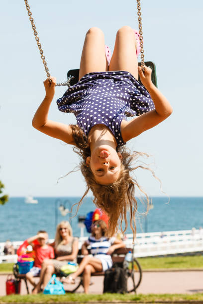 istock Playful crazy girl on swing. 814596256