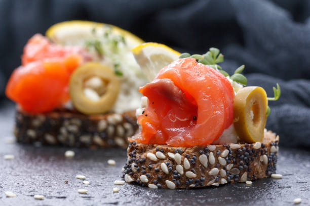 istock Canape with salmon and cheese cheese on a dark background. 814596354