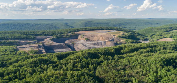 The aerial view to the open-cast mine in Lehigh Valley, Carbon County, Pennsylvania, USA. The aerial view from a drone to the open-cast mine in Lehigh Valley, Carbon County, Pennsylvania, USA. The sunny summer day. carbon county utah stock pictures, royalty-free photos & images