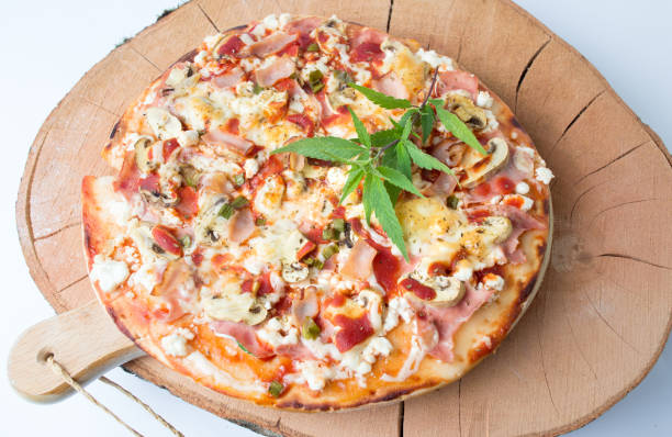 istock Happy pizza with marijuana leaves 814596676
