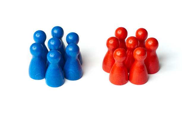 Game figures as a symbol for two groups of people. Concept for teamwork or challange. Isolated on white background