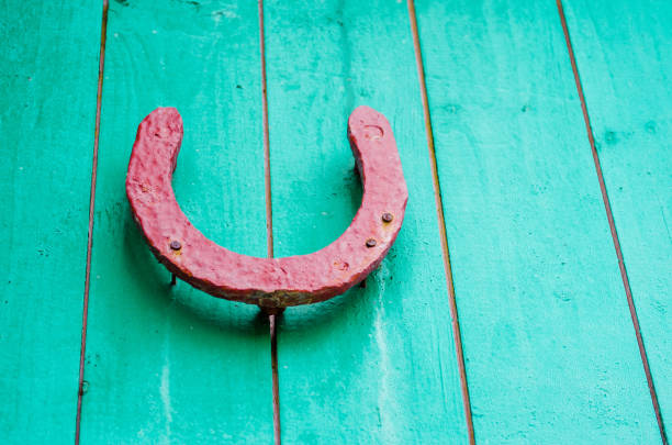 Old lucky horseshoe on red wooden wall
