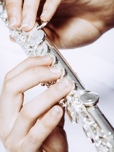 istock Hands of young man playing the flute 814608018