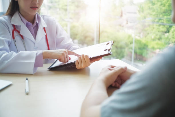 istock Doctor is consulting the patient and lighting on window. 814608746