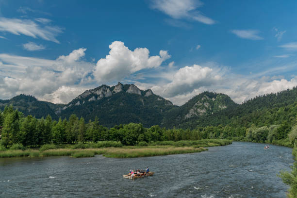 Boats on river Dunajec after rain with blue sky Boats on river Dunajec after rain with blue sky and white clouds szczawnica stock pictures, royalty-free photos & images