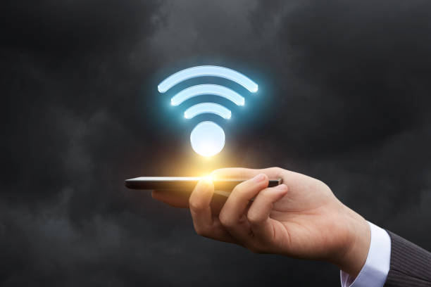 istock Businessman shows a WiFi symbol on the mobile . 814637104