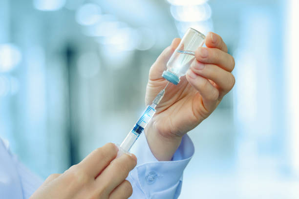 istock Doctor gaining medicine into the syringe . 814637108