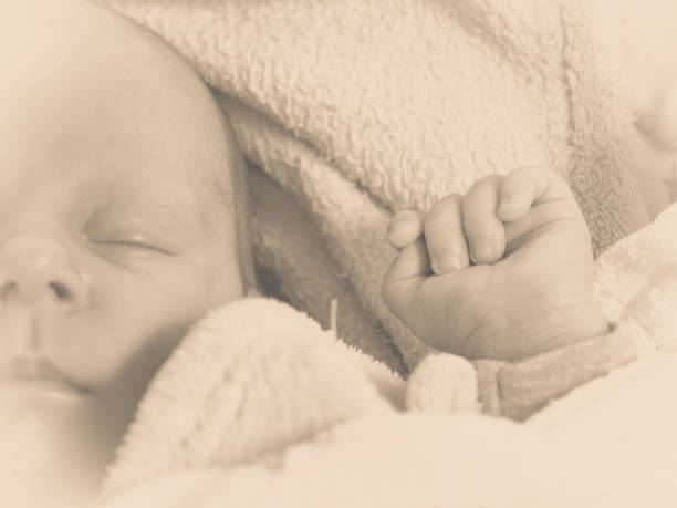 istock Little newborn baby sleeping calmly in blanket 814641528