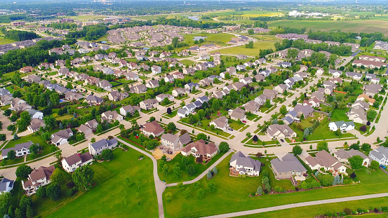 Beautiful suburban neighborhoods, nice homes, aerial view on a July morning.