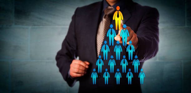 Recruiter Selecting Man Atop Corporate Hierarchy stock photo
