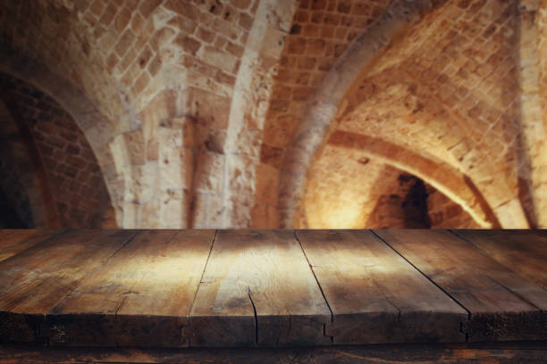 Empty old table in front of ancient knight stone tower. Useful for product display montage.