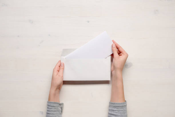 istock Hands of the manager, folding letter in an envelope 814658104