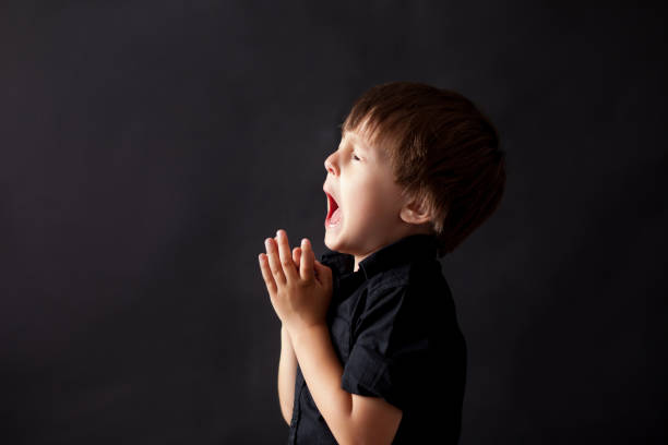 istock Little boy praying, child praying, isolated background 814661104