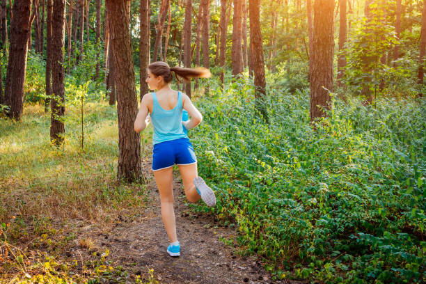 istock Woman running in the forest 814669480