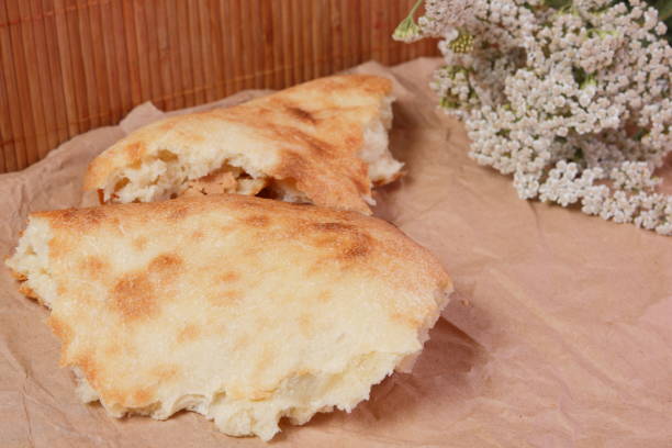 istock Pieces of fresh pita bread in the home kitchen 814672408
