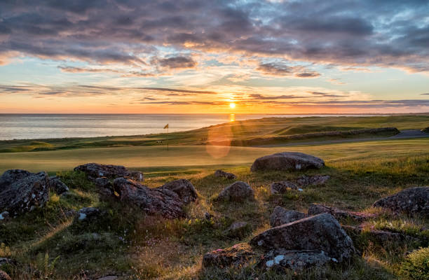 Golf course sunset Hvaleyrarvollur gofl course, shot at sunset looking towards the ocean midnight sun stock pictures, royalty-free photos & images