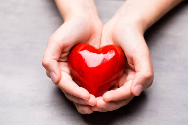 istock Red wood heart in child hands 814712042