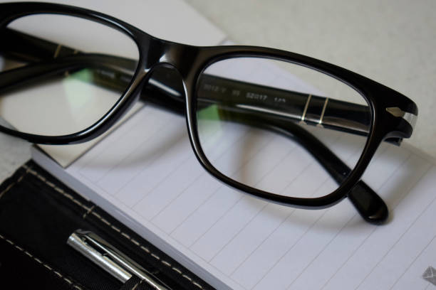 istock Office desk table with glasses and pen 814714520