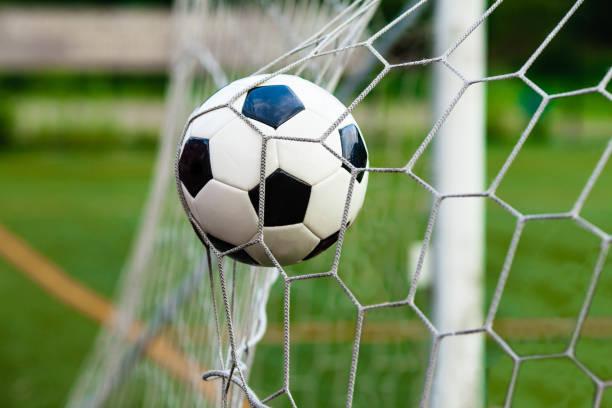 istock Soccer ball in goal 814722018