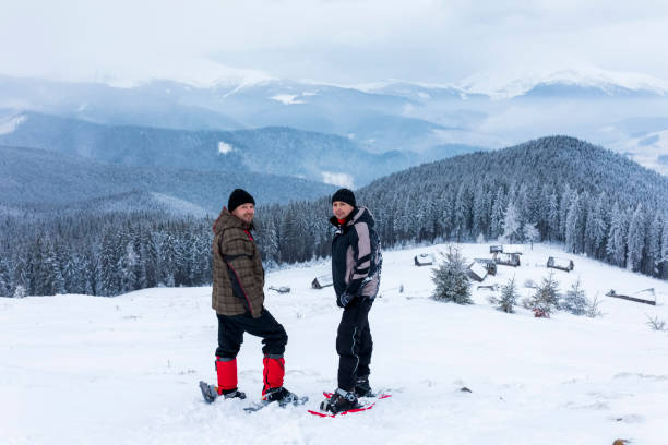 istock Two man on Snowshoeing look at mountains. 814763786