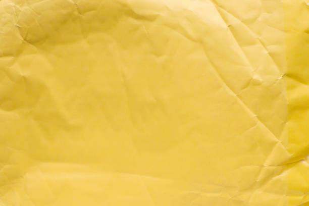 istock Yellow crumpled paper close up. 814778124