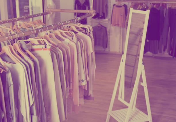 istock Knitted clothing on hangers in garment store 814791178