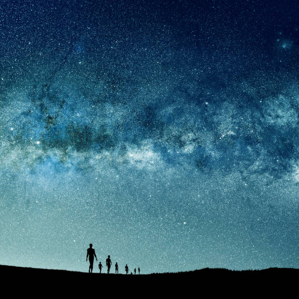 istock silhouetted people over abstract universe lights 814793576