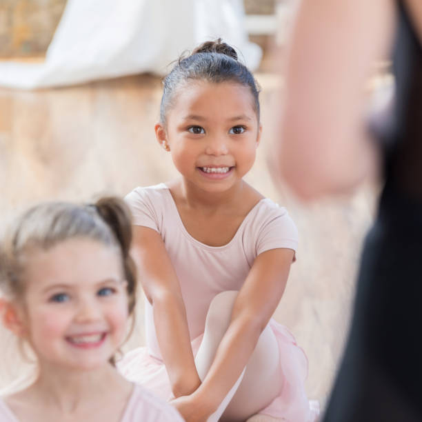 istock Young ballerina listens attentively to instructor 814797062