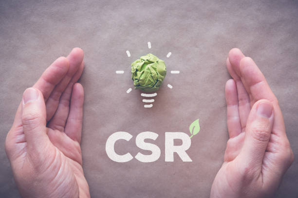 istock Green paper light bulb with CSR, Corporate social responsibility 814829928