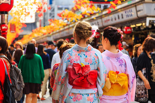 Tokyo, Japan - October 21, 2016: unidentified foreigner tourist wearing kimono, the national tradition costume of Japan walking at Sensoji temple the famous temple in Tokyo, Japan