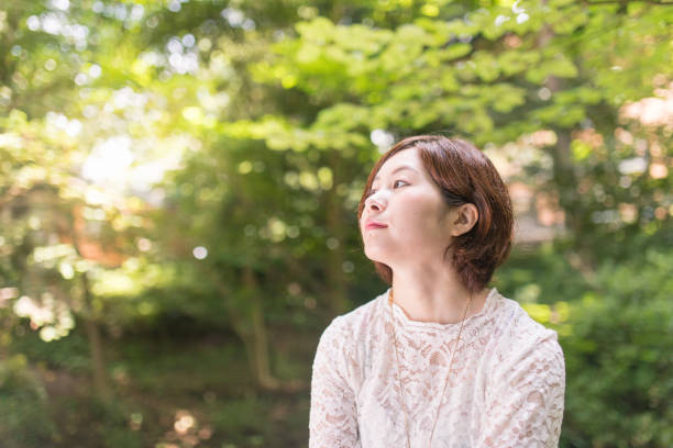 istock Beautiful woman in green forest 814894320