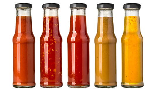 the various barbecue sauces in glass bottles