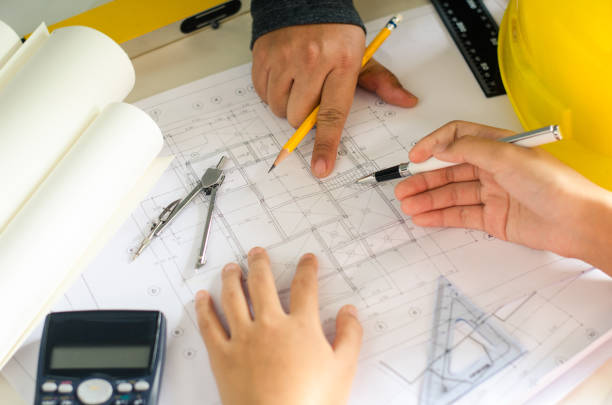 istock Engineering teams are meeting to present and discuss construction work designed and implemented. 814914188