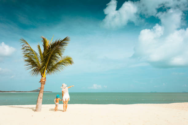 istock Mother and baby on the beach 814928344