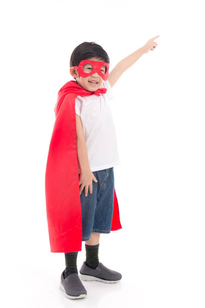 Cute Asian child  in Superhero's costume pointing
