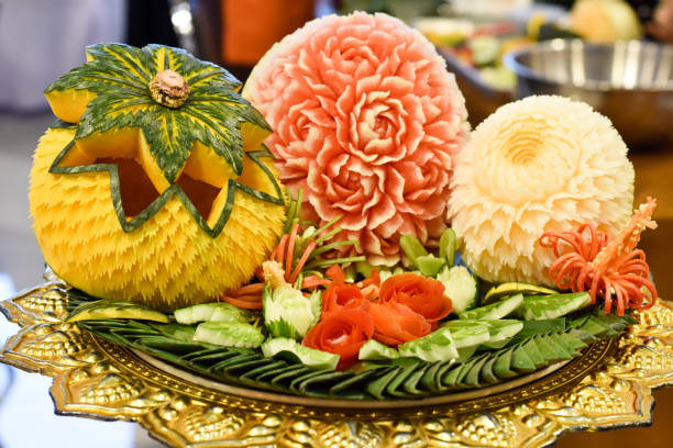 Carving fruit, carving vegetables Carving fruit, carving vegetables fruit carving stock pictures, royalty-free photos & images