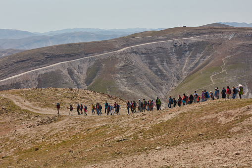 Jerusalem - 10.04.2017: Group of people trekking in the mountais near Jerusalem on their way to the Mar Saba monastery