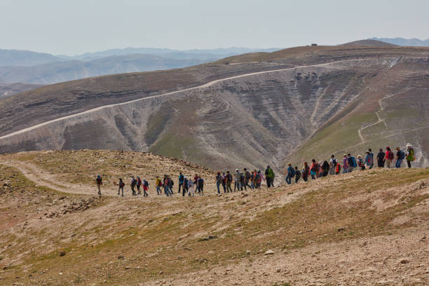 Group of people trekking in the mountais stock photo