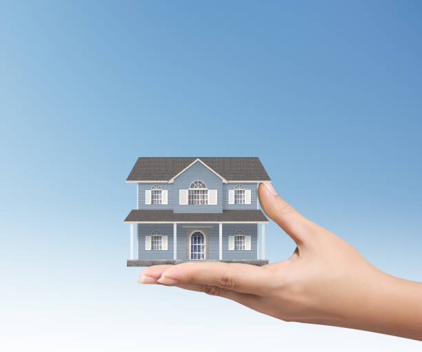 istock Mortgage concept by house from in hand 814962924