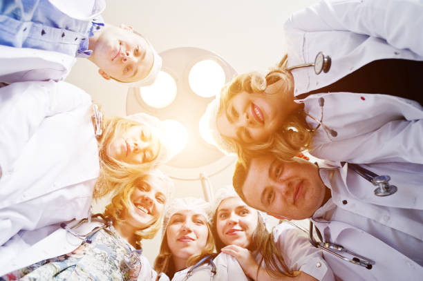 istock Confident and talented surgeons gathered around surgical light in the operating room. 814963258