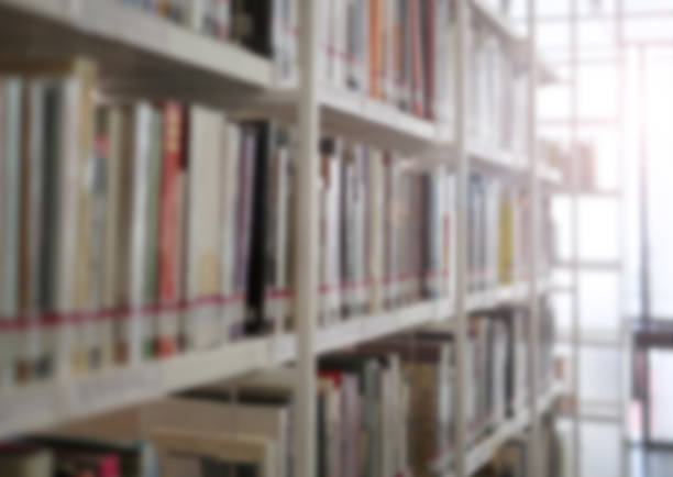 istock books on bookshelf in library, abstract blur defocused background. 814972820