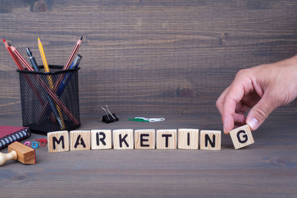 istock marketing. Wooden letters on dark background 814983588