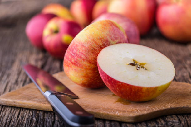 istock Apple. Red Apples in other positions on wooden board 814988686