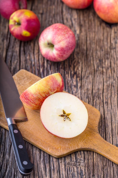 istock Apple. Red Apples in other positions on wooden board 814988706