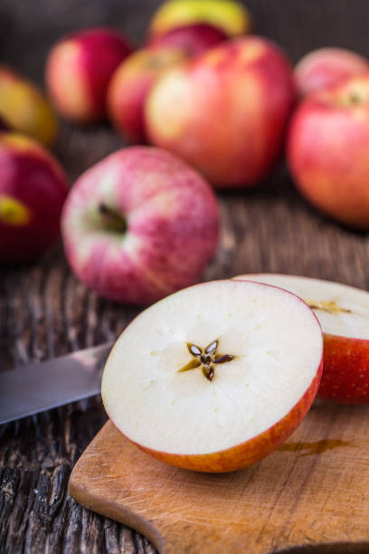 istock Apple. Red Apples in other positions on wooden board 814988886