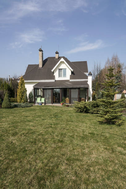 istock Private house with a garden in a rural area under beautiful sky 814992678