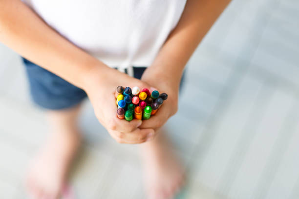 istock child's hands with lots of colorful wax crayons 814993076