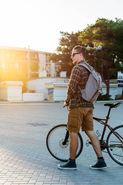 istock Young Man Walking With Bicycle Daily Routine Lifestyle 814995794